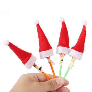 Mini red and white felt Christmas hats used as festive lollipop topper decorations