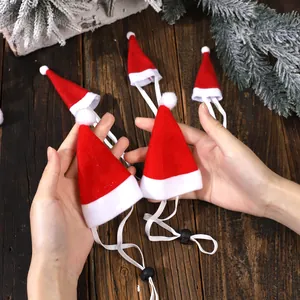 Mini red Christmas hats for small pets with adjustable elastic straps and soft white pom-poms