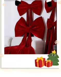 Close-up detail of large red velvet Christmas bow decoration with long flowing ribbons.