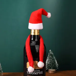 Detailed macro view of a festive red Santa hat and scarf wine bottle decoration set