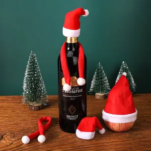 Mini red and white Christmas hats and scarves used for wine bottle and apple decoration.