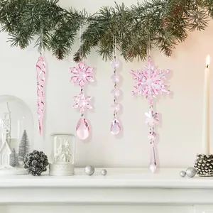 Pink crystal Christmas snowflake and icicle ornaments hanging from festive garland
