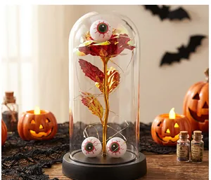 Rosa de Halloween bajo cúpula de cristal con ojos decorativos y luces