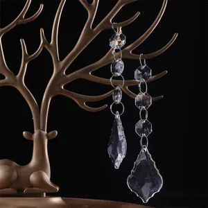 Detailed view of elegant transparent crystal bead hanging ornaments on a gold stand.