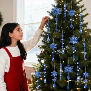 Detail view of blue acrylic snowflakes and icicles hanging on a Christmas tree.