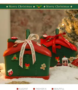 Vista dettagliata delle scatole regalo natalizie a forma di casa con nastri.