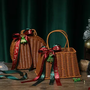 Two woven Christmas gift baskets with festive red and green ribbons on wooden table.