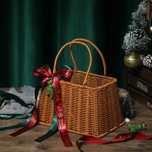 Handmade woven Christmas gift basket with red and green decorative festive ribbon ties