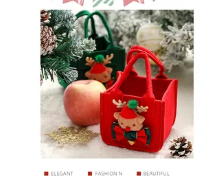 Detail of Christmas felt gift bags with reindeer decoration for apples and candies