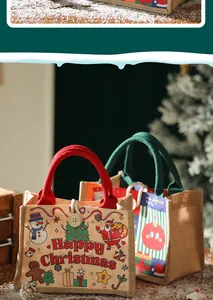 Sacchetti regalo natalizi in tela con motivi di Babbo Natale e manici robusti