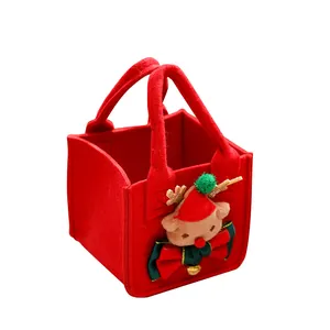 Red Christmas felt gift bag with cute reindeer decoration and bow for candy packing.