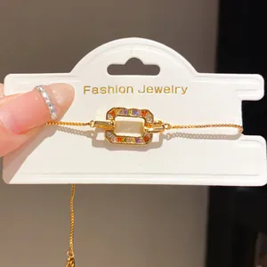 Detail of 18K gold-plated bracelet with vibrant rainbow zircons on display card