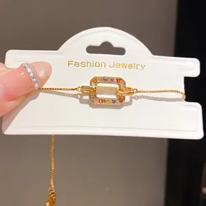 Detailed macro view of 18K gold plated bracelet with colorful rainbow zircon pendant