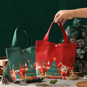 Sac cadeau de Noël festif en toile avec illustrations de Père Noël et de rennes décoratifs
