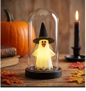 Close-up detail of a glowing Halloween ghost night light with a black wizard hat