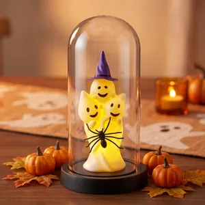 Glowing Halloween ghost trio in a glass dome with a purple witch hat ornament.