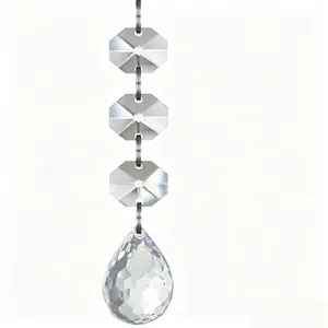 Close-up of transparent faceted octagonal beads and a teardrop crystal pendant hanging