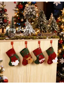 Detailansicht von Weihnachts-Hängesocken mit Weihnachtsmann und Rentier in Weihnachtsdeko