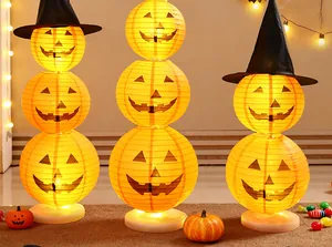 Decorative Halloween pumpkin paper lantern columns featuring warm LED light bases and witch hats