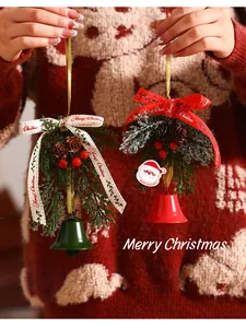 Macro detail of festive Christmas tree bell ornaments with pine cones and red ribbons