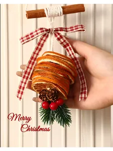 Close-up of a Christmas ornament made from dried orange slices and a checkered bow