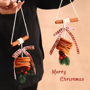 Natural Christmas ornaments featuring dried orange slices and aromatic cinnamon sticks