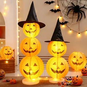 Stackable Halloween pumpkin paper lanterns with witch hats for festive party and home decor.