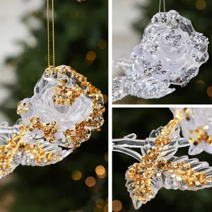 Close-up of transparent acrylic rose Christmas ornaments with sparkling gold glitter detail