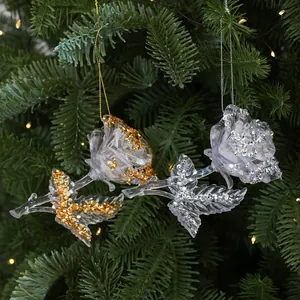 Detailed view of clear acrylic rose ornaments with gold and silver glitter accents.