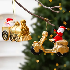Detailed view of gold Santa Claus on a train and scooter Christmas tree hanging ornaments.