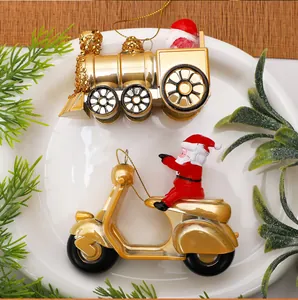 Detailed view of golden Santa Claus train and motorcycle scooter Christmas tree ornaments