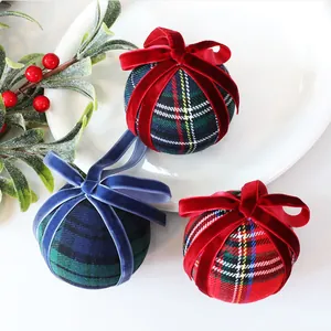 Close-up of 8cm plaid Christmas balls with plush velvet bows and festive textures