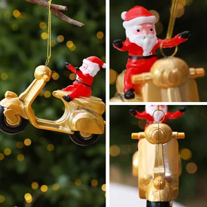 Santa Claus riding a golden scooter Christmas tree ornament hanging on a branch