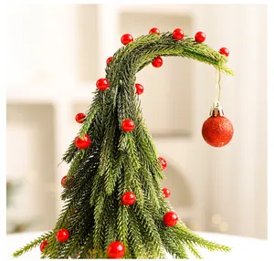 Creatieve gebogen tafelkerstboom met rode bessen en een rode glitter kerstbal dako