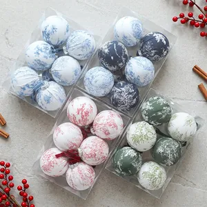 Detailed view of printed fabric Christmas ball ornaments in festive gift boxes