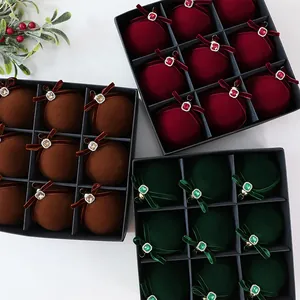Detailed view of luxury velvet Christmas ornaments with rhinestones in gift boxes