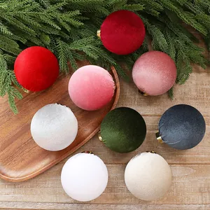 Close-up of assorted velvet fabric Christmas ball ornaments in festive colors