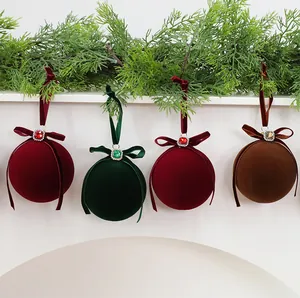 Close-up of velvet Christmas ornaments with rhinestones and ribbon bows