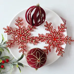 Detailed view of luxury red velvet Christmas balls and golden glitter snowflake ornaments