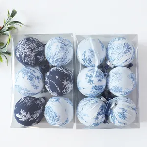 Detailed view of 8cm Christmas balls wrapped in elegant blue and white Toile de Jouy fabric.