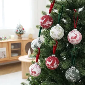 Detailed view of cloth-wrapped Christmas baubles with reindeer prints on a tree
