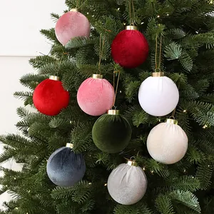 Set of multi-colored velvet Christmas ball ornaments displayed on a festive tree