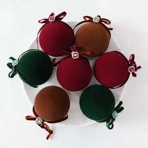 Elegant velvet Christmas ball ornaments with rhinestones in burgundy, green, and brown.