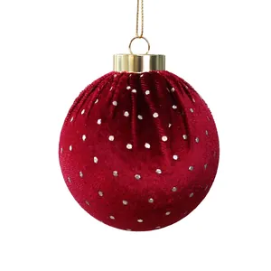 Elegant red velvet Christmas ball ornament with white polka dots and gold string