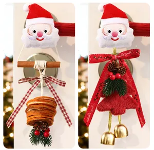 Detailed close-up of plush Santa door handle ornaments with dried orange slices and golden bells