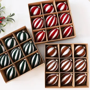 Top view of three sets of striped Christmas ornaments in red, green, and brown