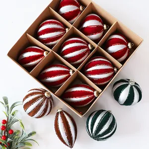 Close-up of painted Christmas ball set with glitter stripes in gift box packaging