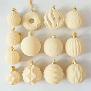 Assortment of elegant cream flocked Christmas ornaments with various textures and shapes