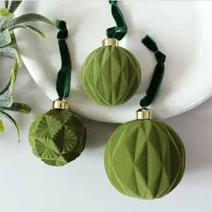 Detailed macro shot of green flocked velvet Christmas ornaments with geometric textures