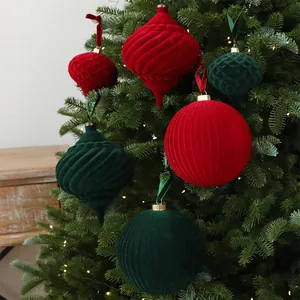 Detail of red and green flocked velvet Christmas ornaments on a Christmas tree